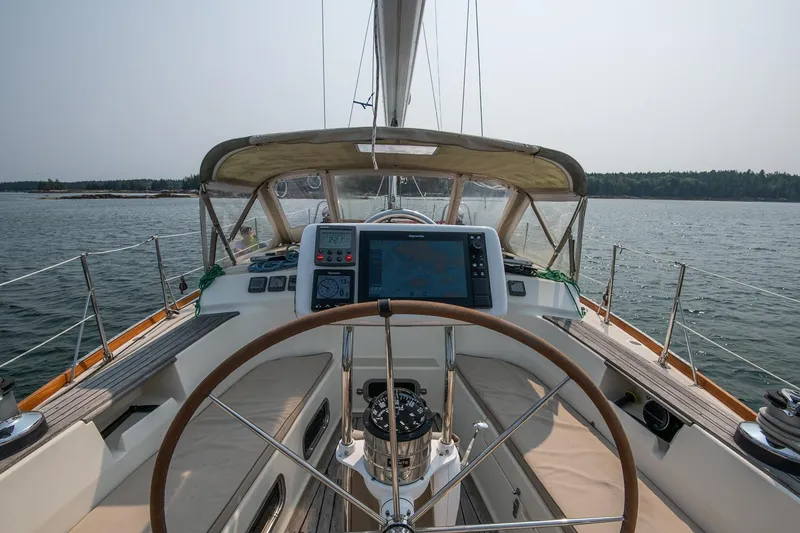 Slide: The Image of Cockpit view of 2002 Tartan 4100 sailboat with navigation equipment on calm waters. - 29