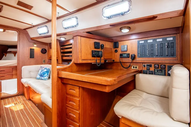 Slide: The Image of Interior of 2002 Tartan 4100 sailboat with navigation station and seating area. - 34