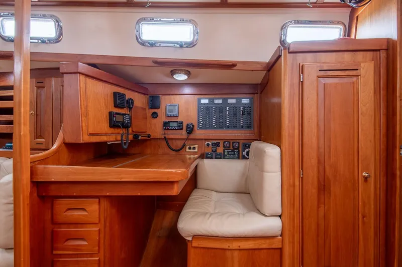 Slide: The Image of Interior of 2002 Tartan 4100 sailboat with navigation station and wooden cabinetry. - 35