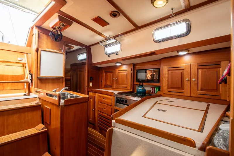 Slide: The Image of Interior of 2002 Tartan 4100 sailboat with wooden cabinetry and modern amenities. - 41