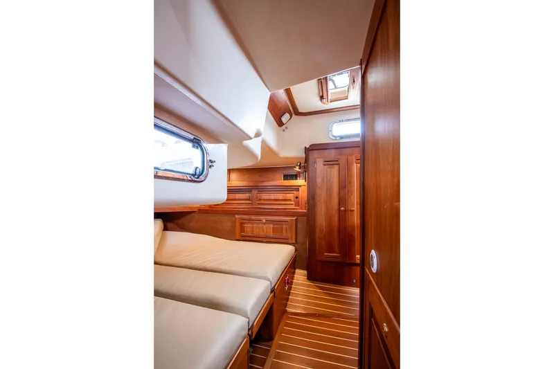 Slide: The Image of Luxurious cabin interior of 2002 Tartan 4100 yacht with wooden finishes and cozy bedding. - 42