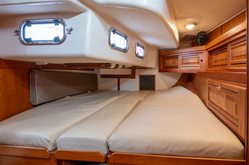 Slide: The Image of Luxurious cabin interior of 2002 Tartan 4100 yacht with wooden cabinetry and comfortable bedding. - 44