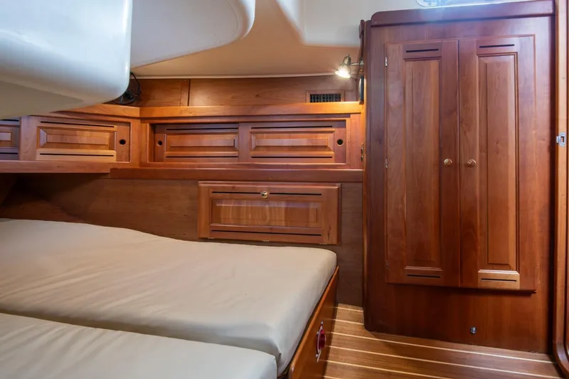 Slide: The Image of Luxurious wooden cabin interior of 2002 Tartan 4100 yacht with cozy bedding. - 45