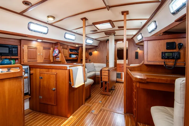 Slide: The Image of Interior of a 2002 Tartan 4100 sailboat with wooden cabinetry and seating. - 46