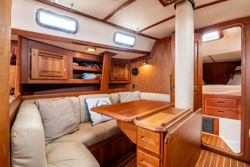 Slide: The Image of Cozy interior of 2002 Tartan 4100 sailboat with wooden furnishings and cushioned seating. - 48