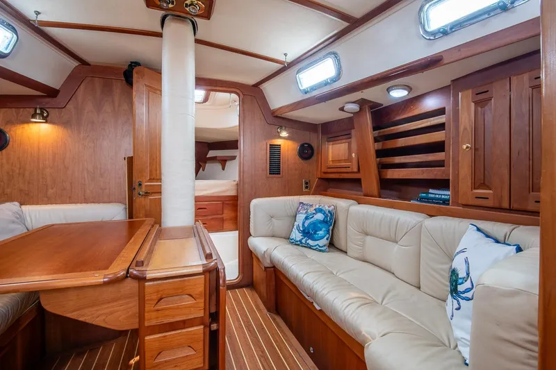 Slide: The Image of Luxurious 2002 Tartan 4100 yacht interior with wood finish and plush seating. - 49