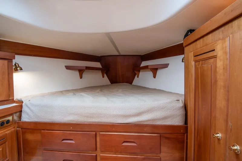 Slide: The Image of Cozy cabin interior of 2002 Tartan 4100 sailboat with wooden furnishings and bed. - 51