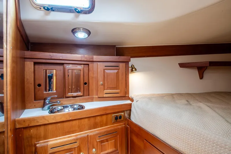 Slide: The Image of Cozy 2002 Tartan 4100 yacht cabin with wooden cabinetry and bed. - 52
