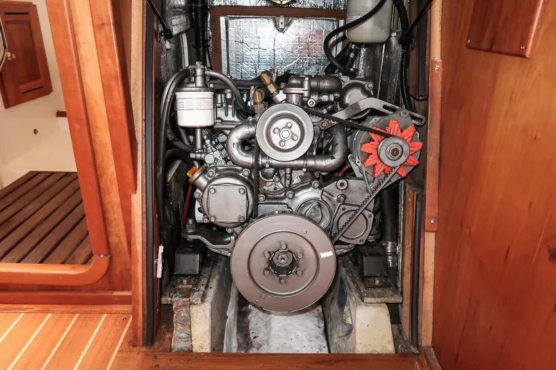 Slide: The Image of Engine compartment of a 2002 Tartan 4100 sailboat, showcasing mechanical components. - 56