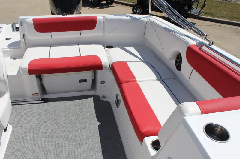 Slide: The Image of 2022 Tahoe 2150 boat interior with red and white seating, cup holders, and storage. - 12