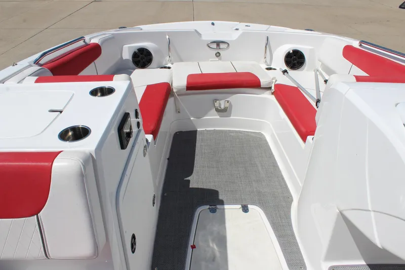 Slide: The Image of 2022 Tahoe 2150 boat interior with red seating, cup holders, and speakers. - 19