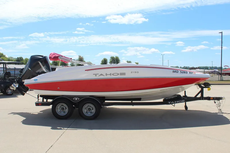 Slide: The Image of 2022 Tahoe 2150 boat on trailer, red and white design, parked outdoors. - 4