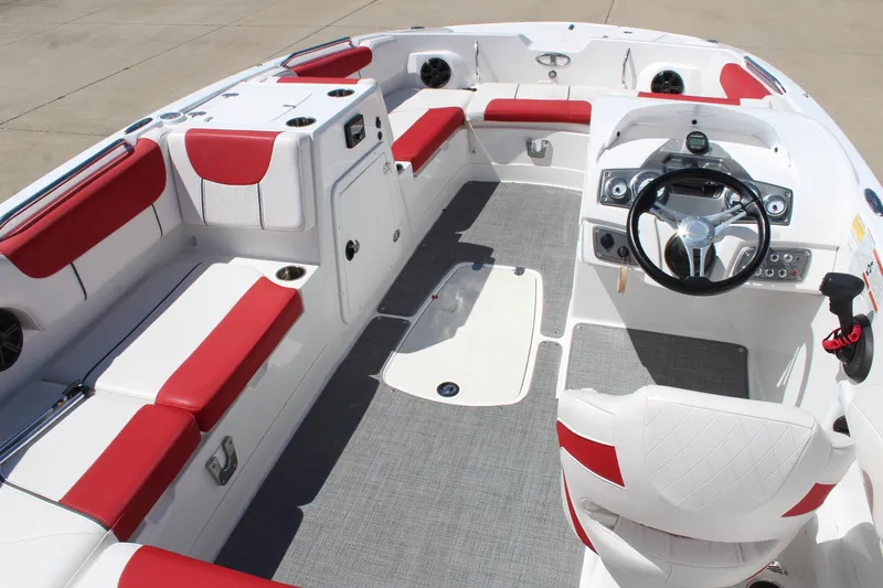 Slide: The Image of 2022 Tahoe 2150 boat interior with red and white seating, steering wheel, and control panel. - 8
