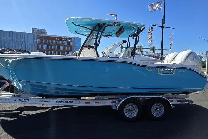 The Image of 2026 Key West 263 FS boat on trailer, blue hull, outdoor display. - 1