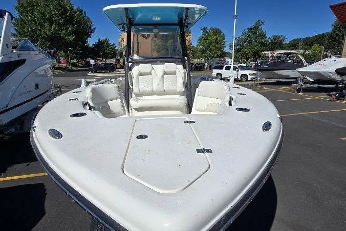 Slide: The Image of 2026 Key West 263 FS boat with spacious seating, parked outdoors under clear blue sky. - 3