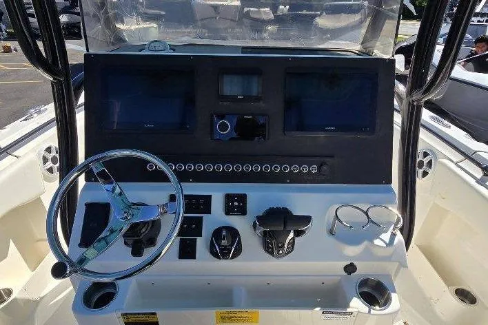 Slide: The Image of 2026 Key West 263 FS boat dashboard with steering wheel and control panel. - 5