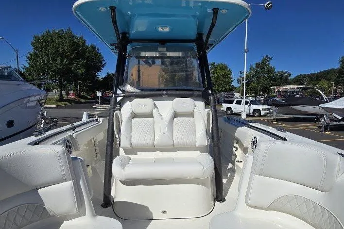 Slide: The Image of 2026 Key West 263 FS boat interior with white seating and blue canopy. - 6