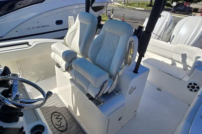 Slide: The Image of 2026 Key West 263 FS boat interior with luxurious seating and steering wheel. - 7