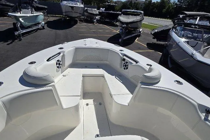 Slide: The Image of 2026 Key West 263 FS boat interior with seating and storage, parked among other boats. - 8