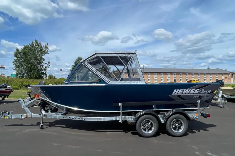 The Image of 2026 Hewescraft 200 ProV boat on trailer under blue sky. - 0