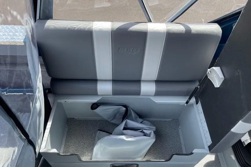 Slide: The Image of 2026 Hewescraft 200 ProV boat seat with storage compartment open, revealing interior space. - 13