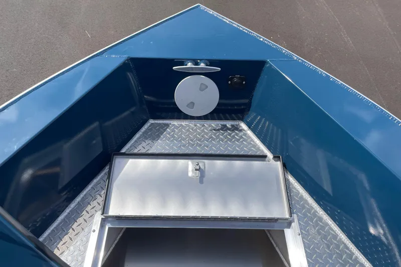 Slide: The Image of 2026 Hewescraft 200 ProV boat interior with diamond plate flooring and storage compartment. - 20