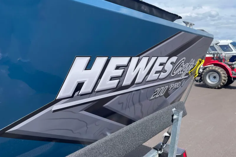 Slide: The Image of 2026 Hewescraft 200 ProV boat with bold logo on blue hull. - 23