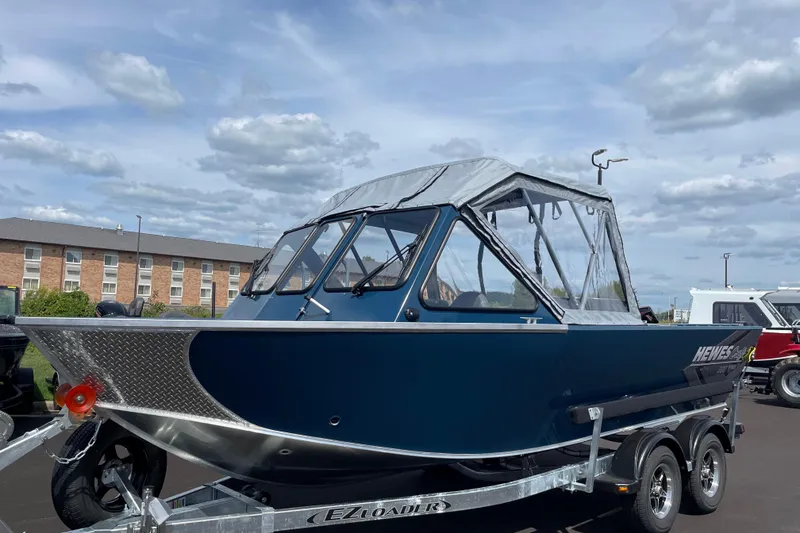 Slide: The Image of 2026 Hewescraft 200 ProV boat on trailer under cloudy sky. - 3