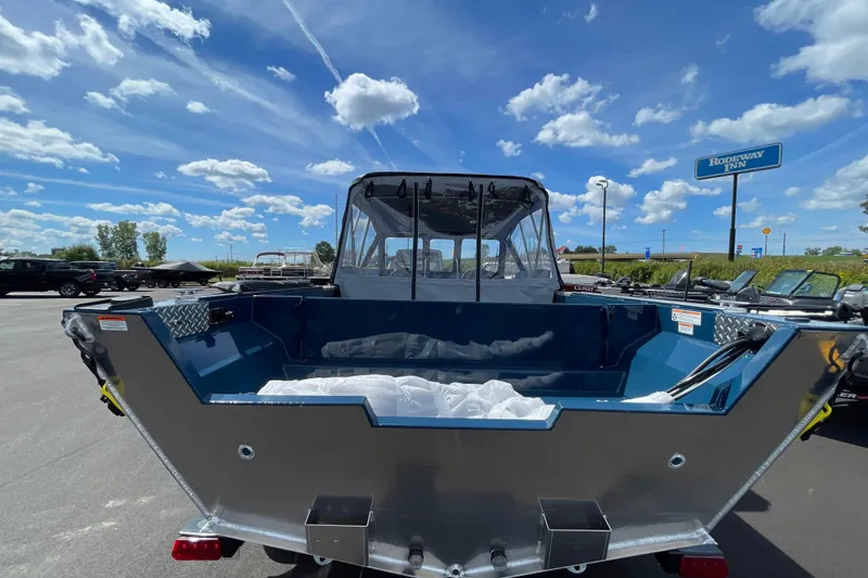 Slide: The Image of 2026 Hewescraft 200 ProV boat under a bright blue sky with scattered clouds. - 4