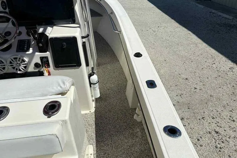 Slide: The Image of 2001 May-Craft 2300 CC boat interior with steering console and seating. - 10