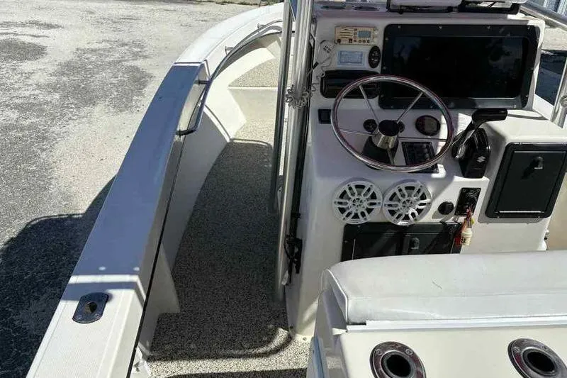 Slide: The Image of 2001 May-Craft 2300 CC boat interior with steering wheel and control panel. - 11