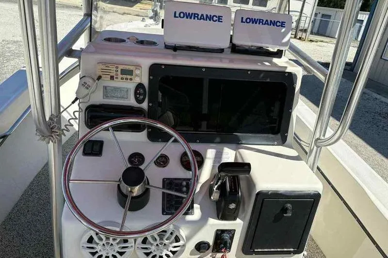 Slide: The Image of 2001 May-Craft 2300 CC boat console with Lowrance navigation equipment and steering wheel. - 12