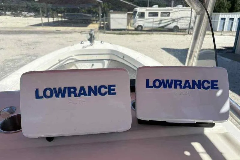 Slide: The Image of 2001 May-Craft 2300 CC boat with Lowrance Elite and Hook devices on dashboard. - 13