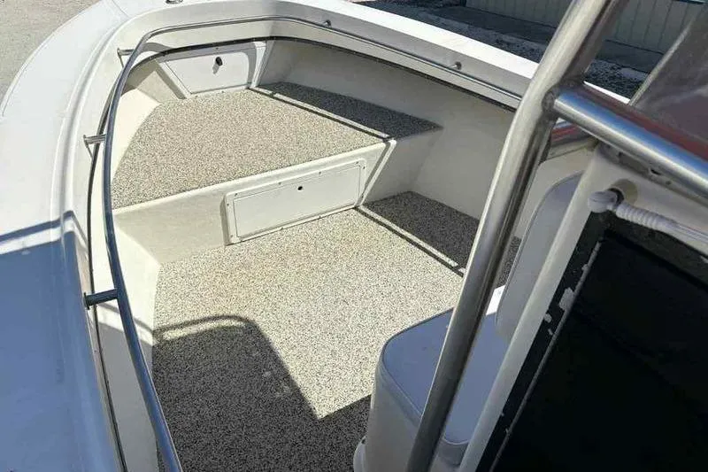 Slide: The Image of 2001 May-Craft 2300 CC boat interior with spacious deck and seating area. - 16