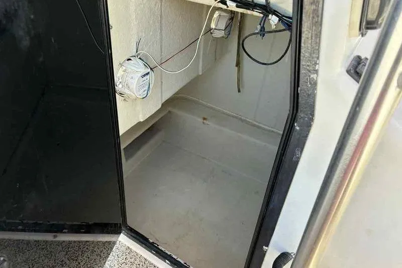 Slide: The Image of Interior view of a 2001 May-Craft 2300 CC boat compartment with wiring. - 17