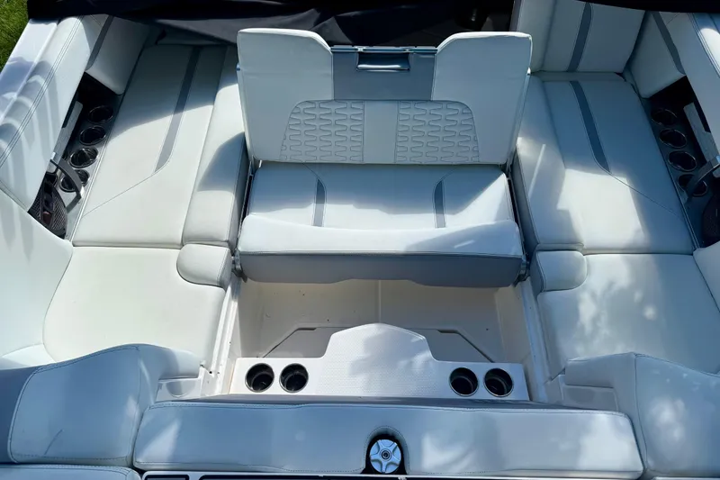 Slide: The Image of 2023 MasterCraft X24 boat interior with white seating and cup holders. - 12