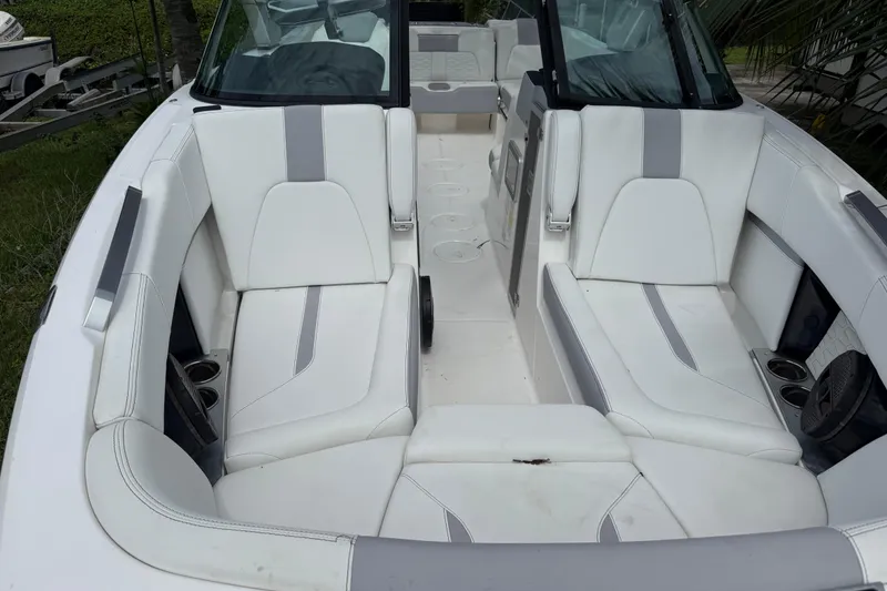 Slide: The Image of 2023 MasterCraft X24 boat interior with white and gray seating, cup holders, and sleek design. - 3