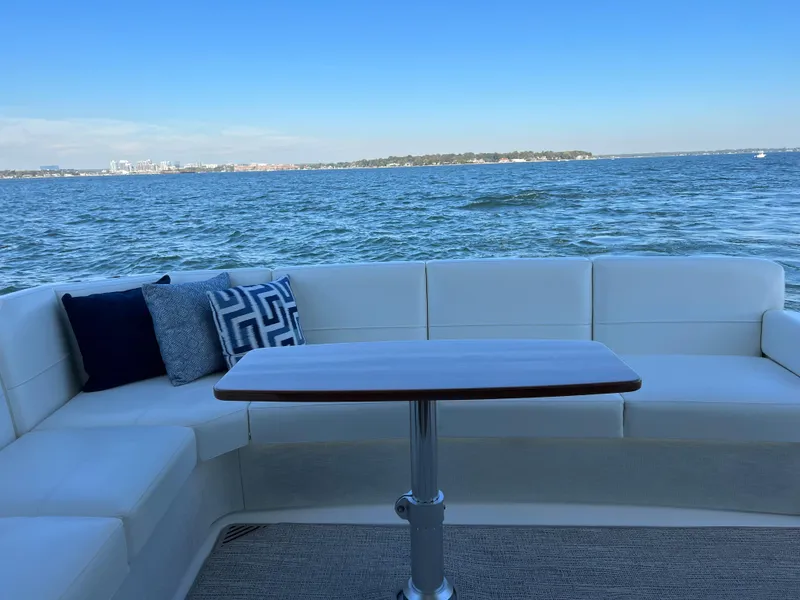Slide: The Image of Luxury seating area on 2021 Tiara Yachts C49 Coupe with ocean view. - 11