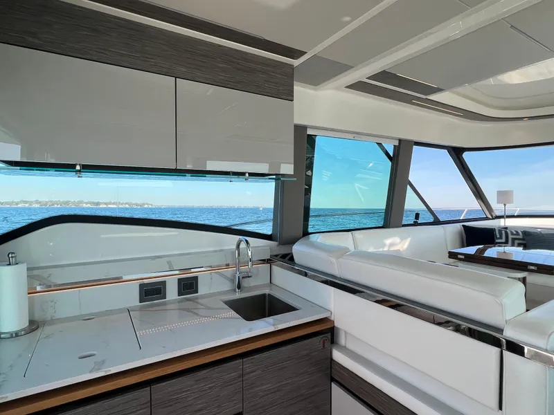Slide: The Image of Interior of 2021 Tiara Yachts C49 Coupe with modern kitchen and ocean view. - 14