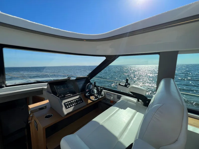 Slide: The Image of Interior view of 2021 Tiara Yachts C49 Coupe, featuring helm and ocean view. - 20