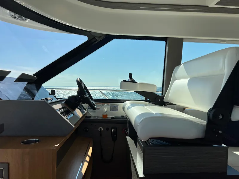 Slide: The Image of 2021 Tiara Yachts C49 Coupe interior with helm and seating, ocean view. - 24
