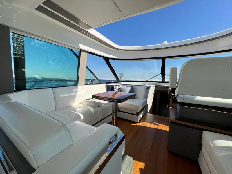 Slide: The Image of Luxurious interior of 2021 Tiara Yachts C49 Coupe with white seating and ocean view. - 26