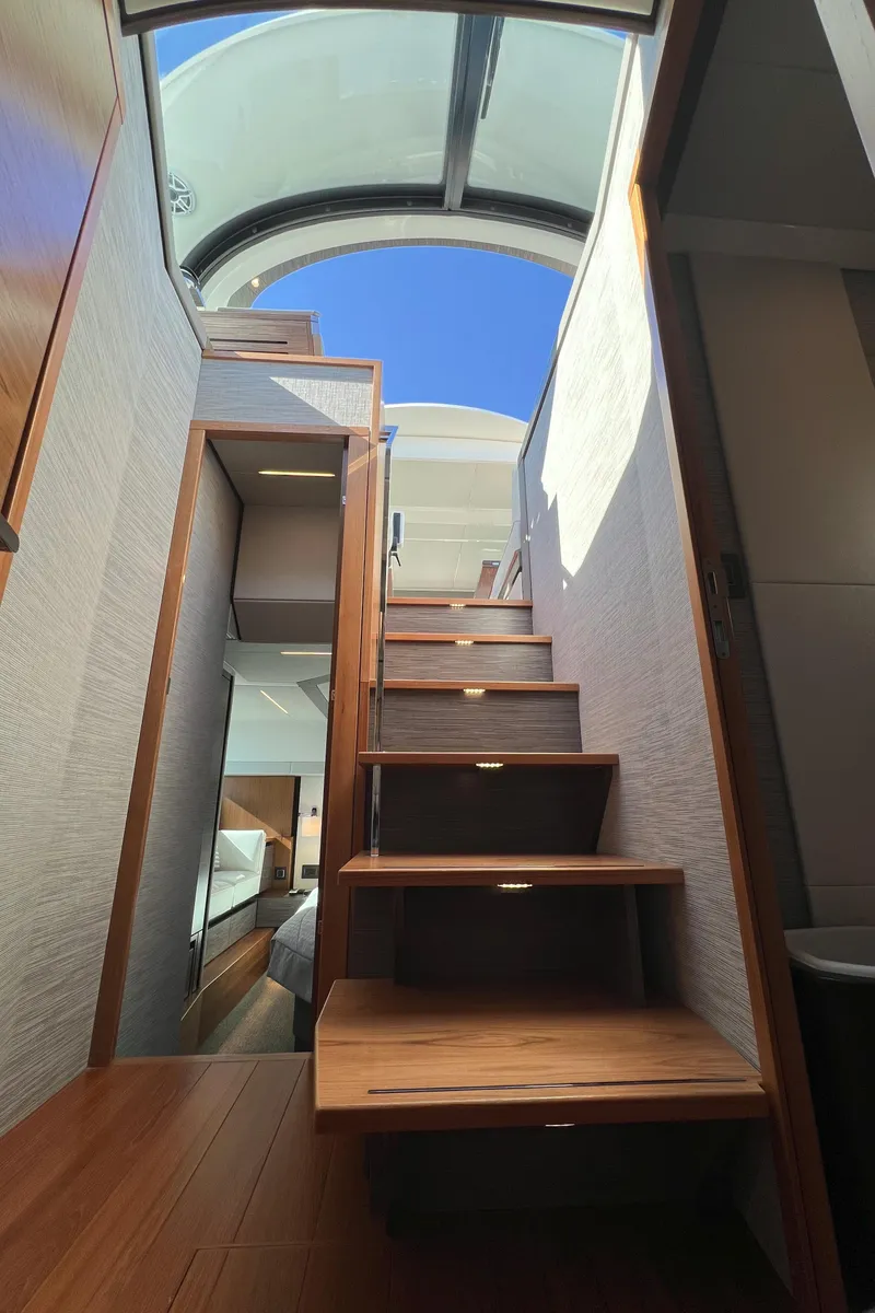 Slide: The Image of Interior staircase of 2021 Tiara Yachts C49 Coupe with skylight view. - 30