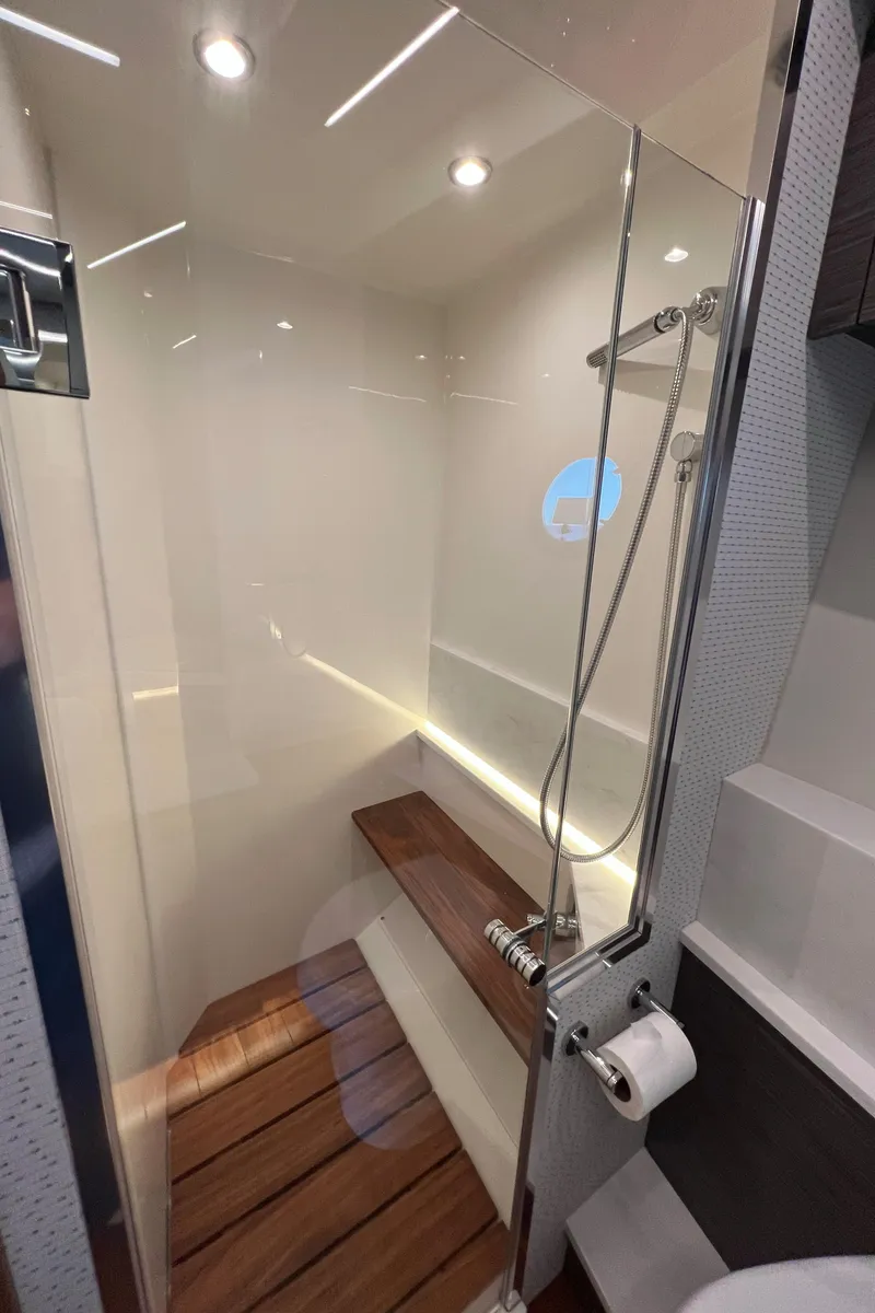 Slide: The Image of 2021 Tiara Yachts C49 Coupe shower with wooden bench and modern fixtures. - 36