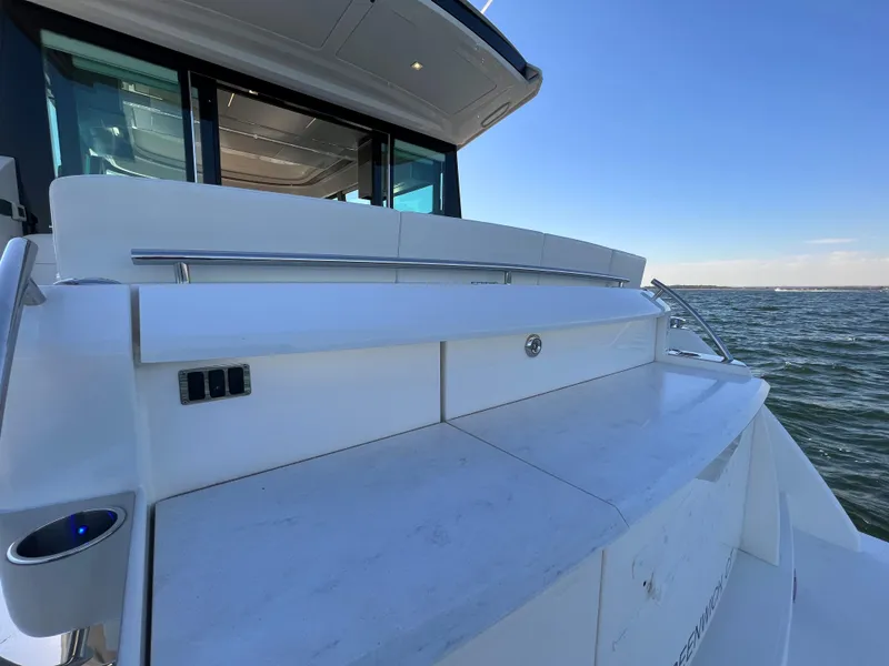 Slide: The Image of 2021 Tiara Yachts C49 Coupe, sleek deck design with ocean view. - 4