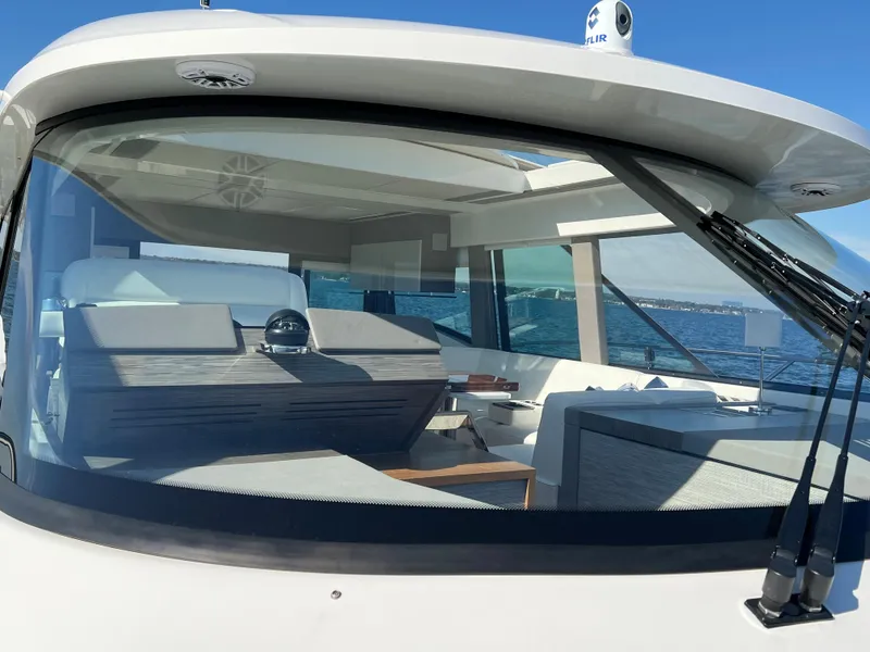 Slide: The Image of 2021 Tiara Yachts C49 Coupe interior view through windshield on open water. - 45