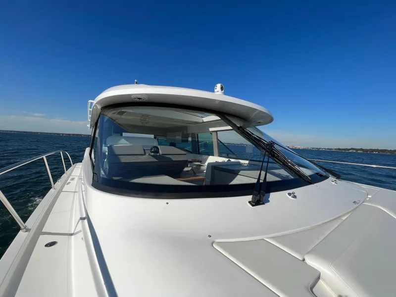 Slide: The Image of 2021 Tiara Yachts C49 Coupe on open water under clear blue sky. - 46