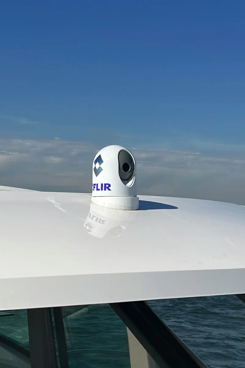 Slide: The Image of FLIR camera on 2021 Tiara Yachts C49 Coupe under clear blue sky. - 48