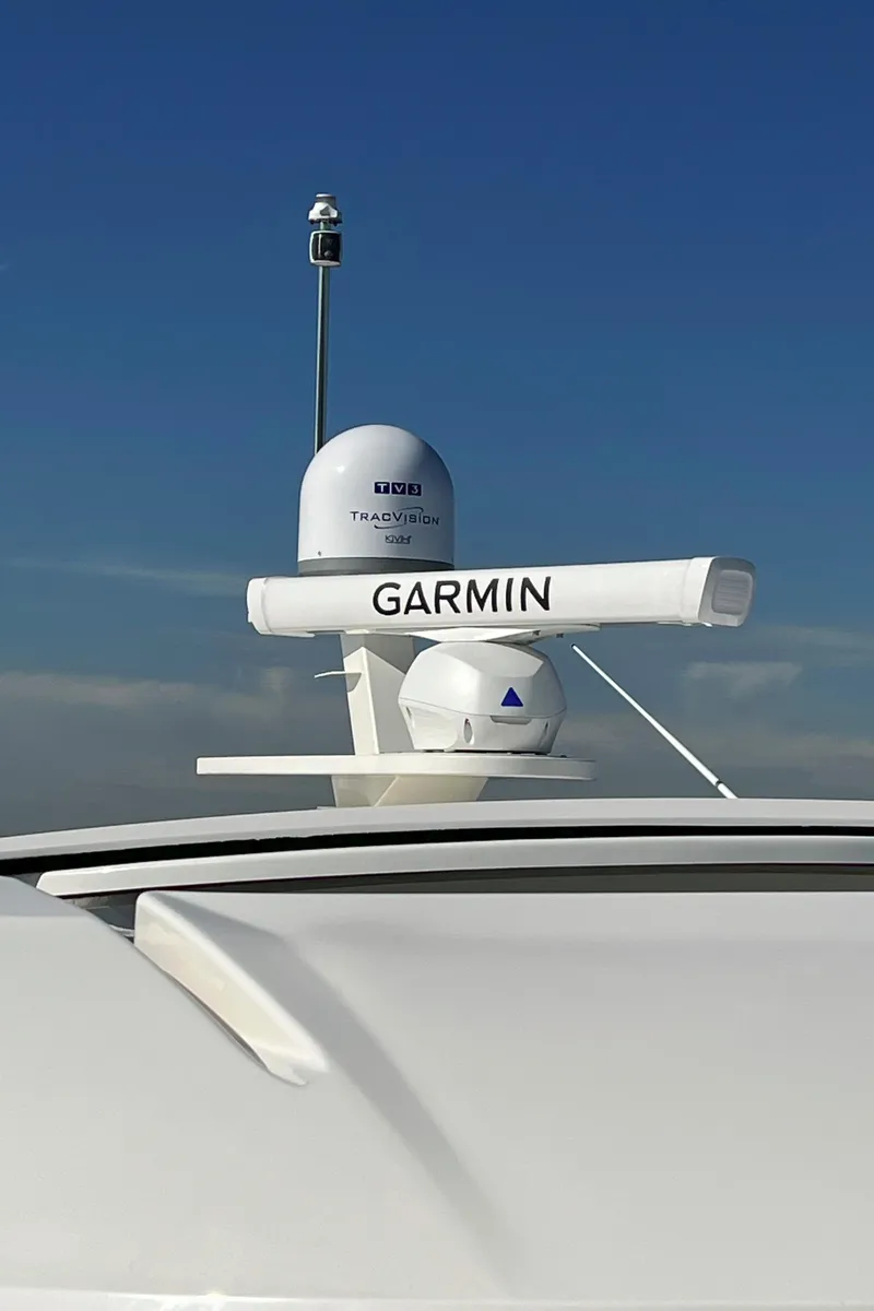 Slide: The Image of Tiara Yachts 2021 C49 Coupe with Garmin radar equipment against clear blue sky. - 49