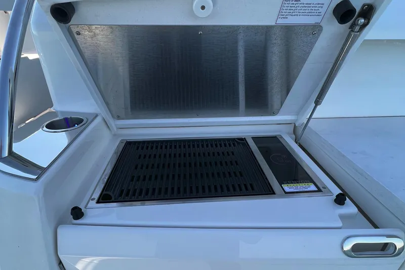 Slide: The Image of Outdoor grill on 2021 Tiara Yachts C49 Coupe, featuring sleek design and stainless steel finish. - 5